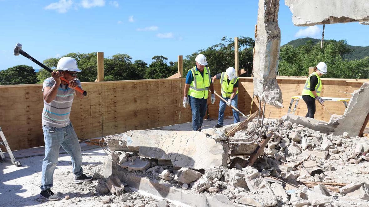 Workers Demolishing A Building To Help Habitat For Humanity